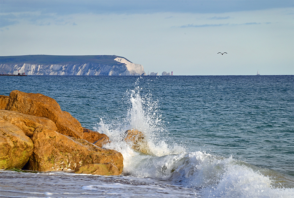 The Needles on the Isle of Wight behind a wave splash