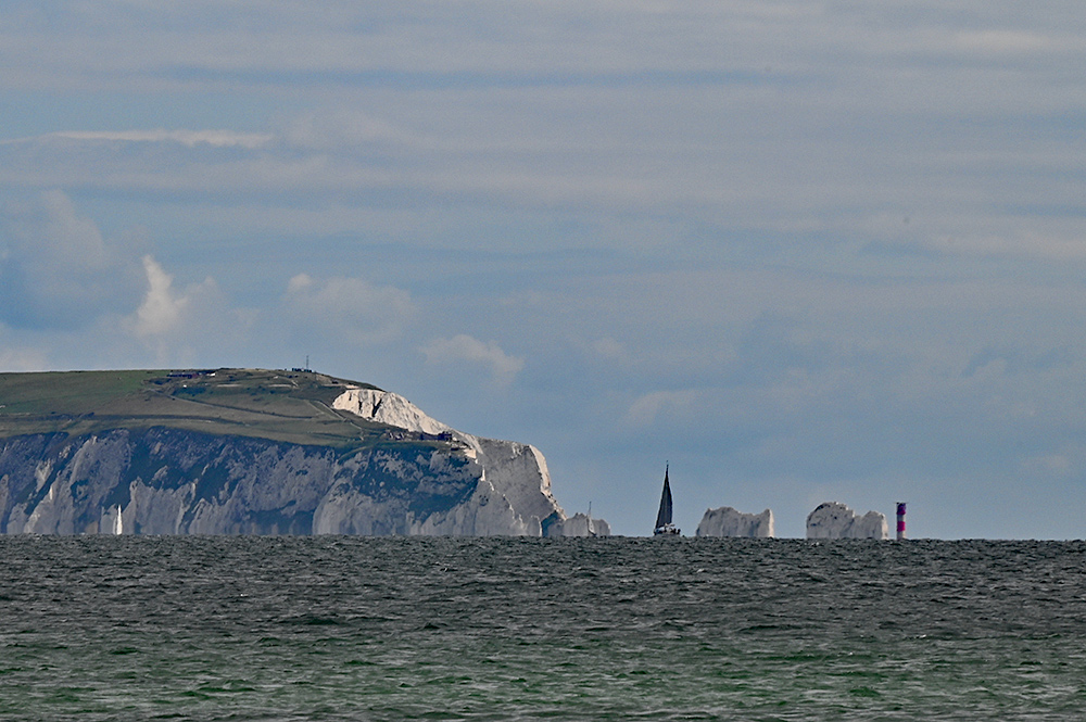 The Needles at the Isle of Wight with passing sailing yachts seen across the sea
