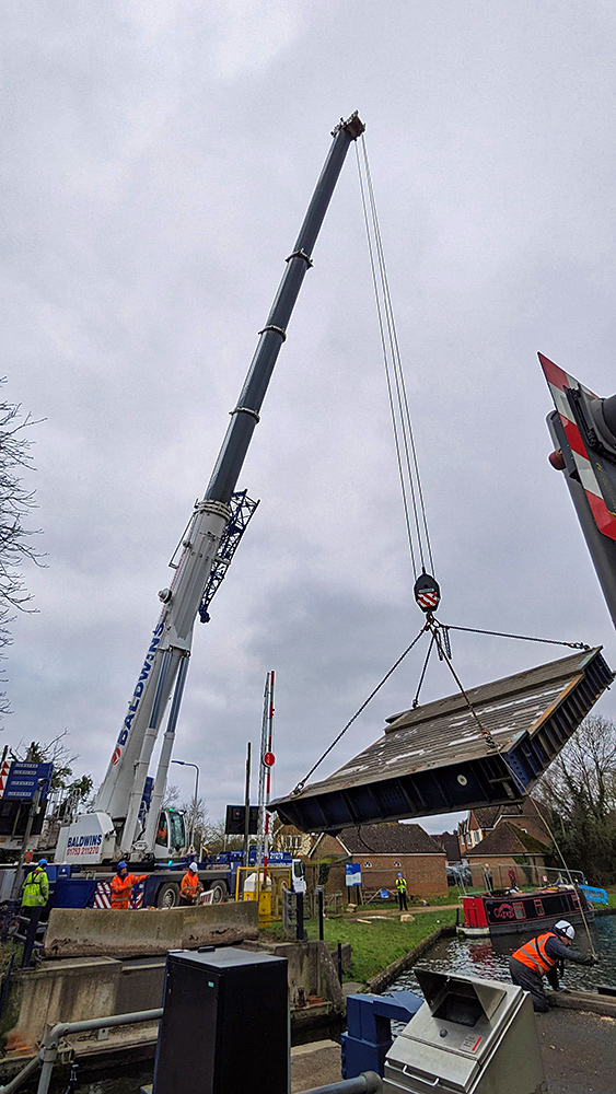 Picture of a lift bridge being hoisted over a canal